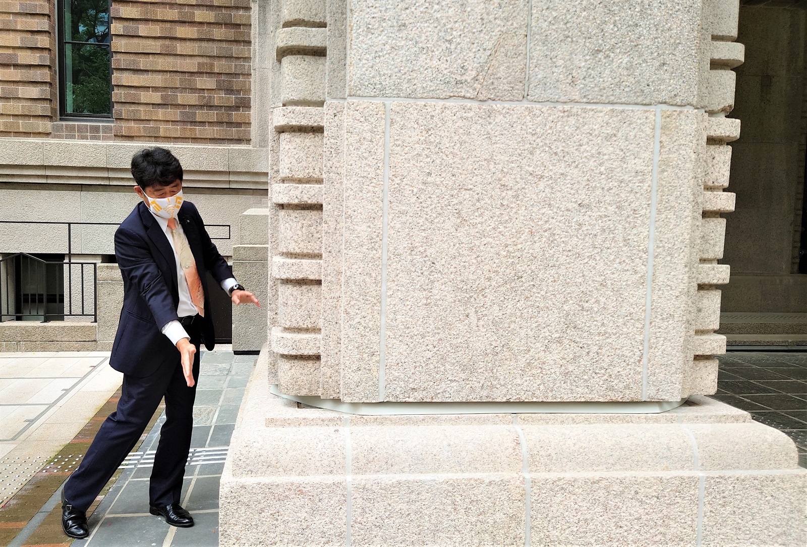 「免震レトロフィット工法」について説明する鹿島の神山良知九段会館テラス新築工事事務所所長。保存棟の地下1階の柱には全て免震装置を設置している（写真：日経クロステック）