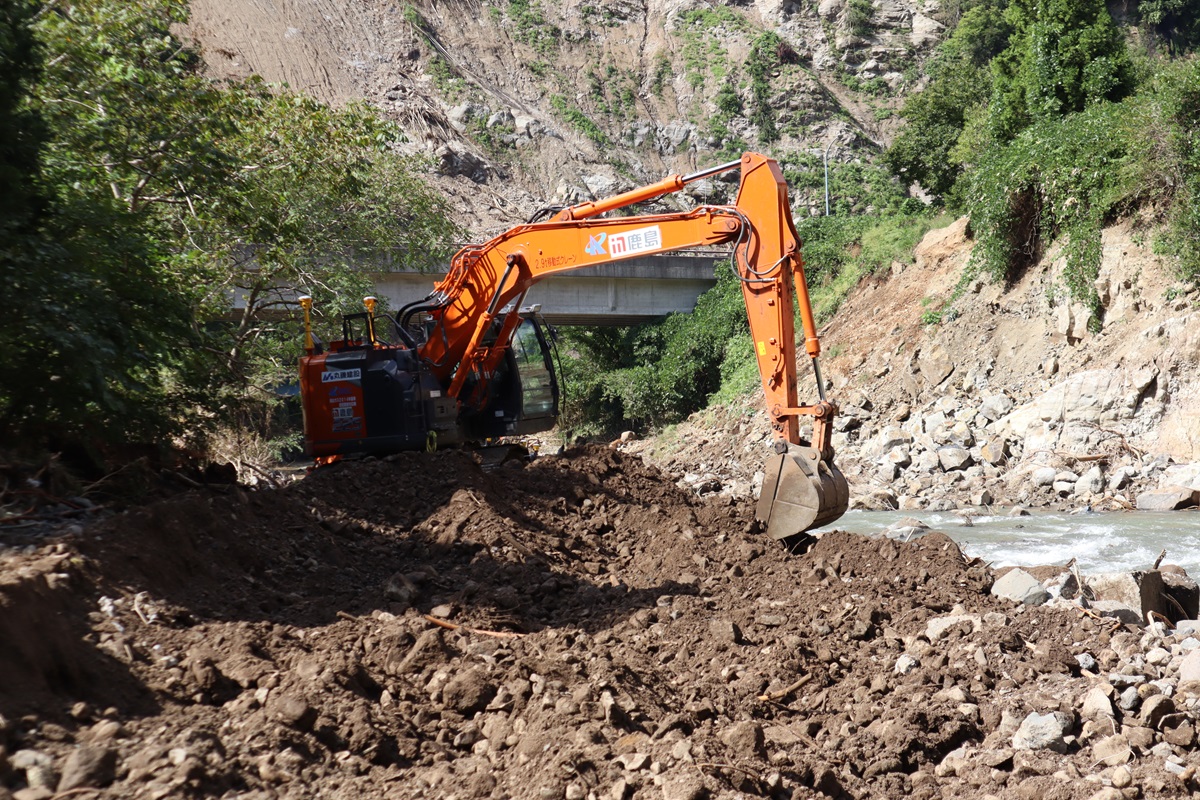 河川護岸が流失した河川工事の応急復旧現場。水みちを確保できるように、重機を使って流失した箇所などをならしている。2024年9月25日撮影（写真：日経クロステック）