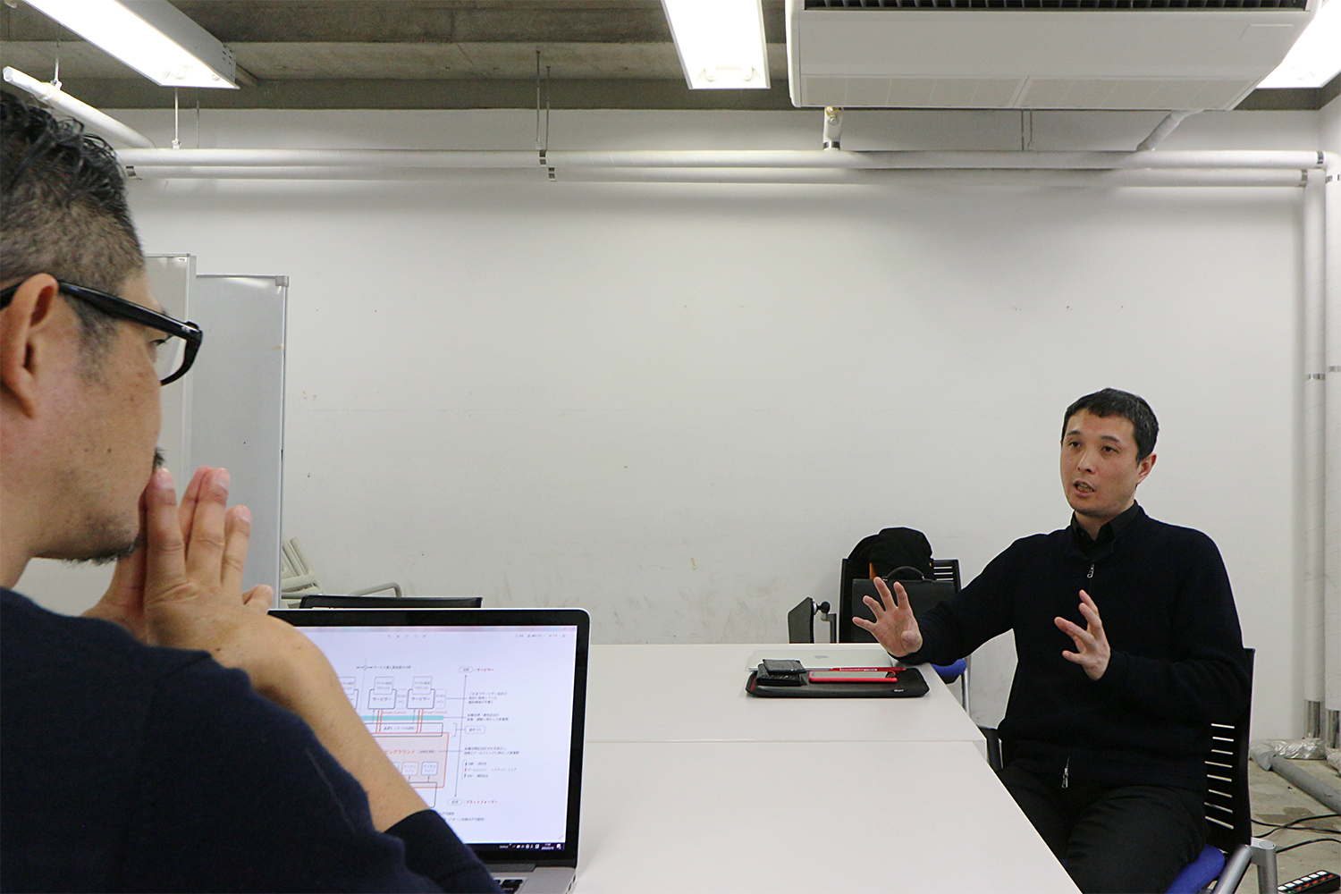 右が、2019年に東京大学先端科学技術研究センター特任准教授に就任した吉村有司氏。noiz共同主宰、gluon共同主宰で建築家の豊田啓介氏（左手前）は20年７月に東京大学生産技術研究所客員教授に就任する。対談収録は20年3月に実施した。両氏のプロフィルは最終ページを参照（写真：日経クロステック）