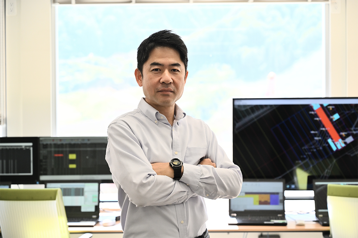 鹿島機械部自動化施工推進室の出石陽一担当部長。1993年鹿島入社。高速道路やダム、シールドトンネルなどの施工に従事し、2017年からクワッドアクセルの開発や運用に携わる（写真：日経クロステック）