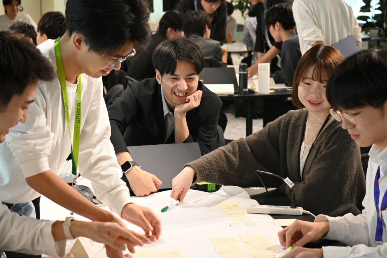 NECが2025年10月に実施した生成AIハッカソンの様子。100人の募集枠に160人以上が応募。選考を経て参加した100人の新入社員が20チームに分かれ、アプリを開発して競った