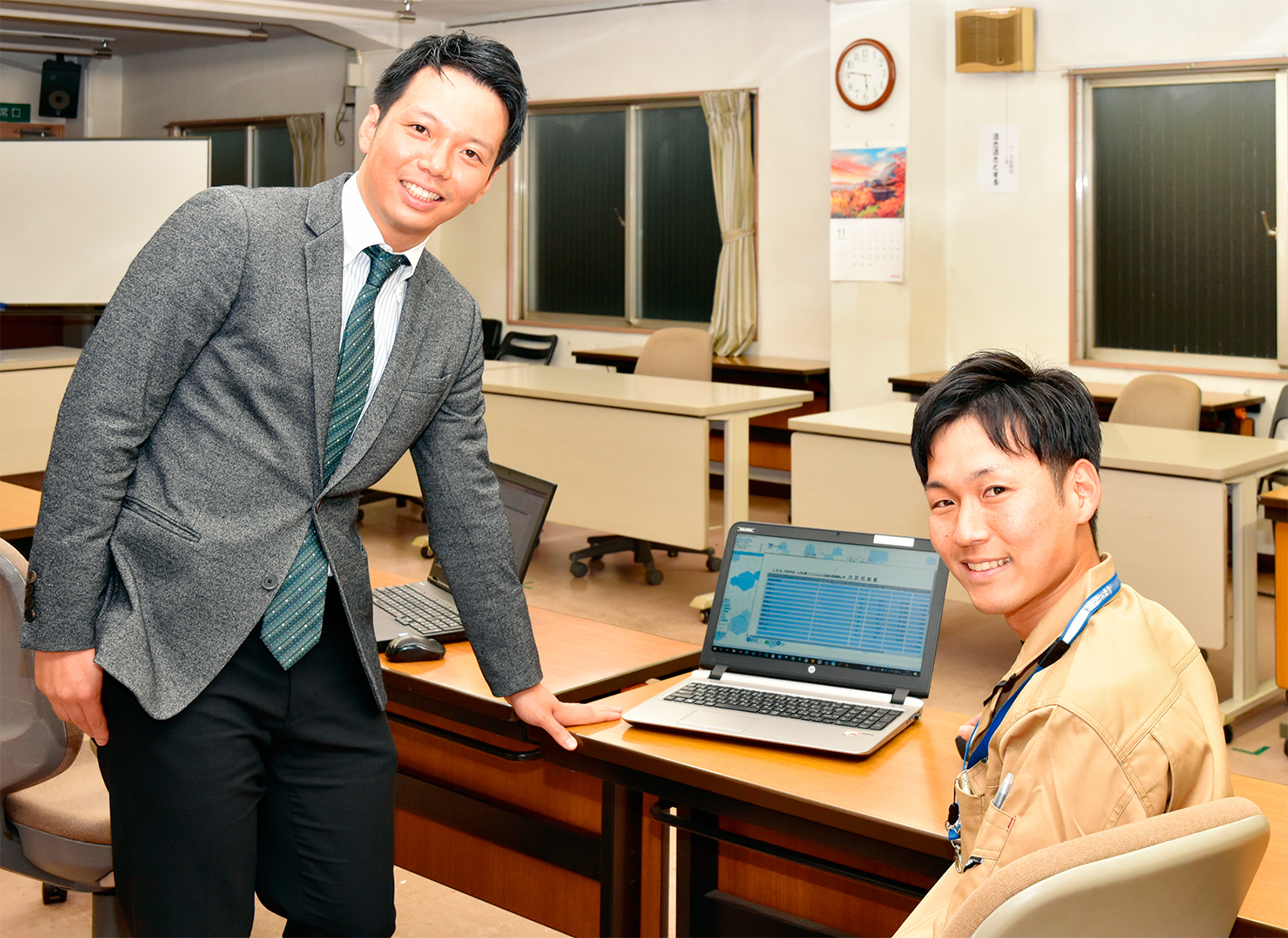 写真1■ 光建の正田光次朗取締役（写真左）は、現場支援チームの望月隆義主任（同右）らと書類業務の自動化に取り組む（写真：日経コンストラクション）