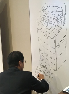 ホワイトボードに絵を描いて説明する玉井氏